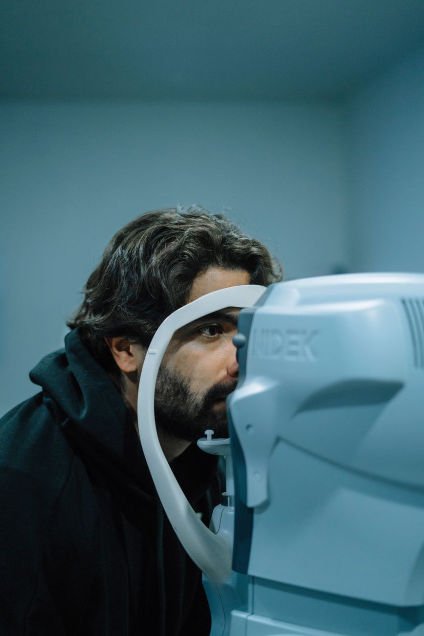 A patient at an autorefractor during an eye examination